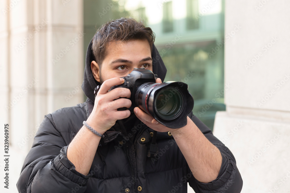 Young photographer taking photos on the streets of the city Young photographer taking photos on the streets of the city