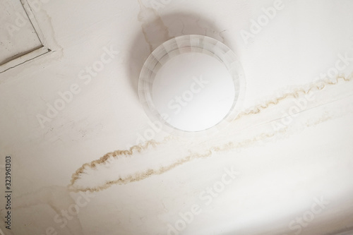 Rain water leaks on the ceiling causing damage, tiles and gypsum board.Dangerous if an electric shock occurs.