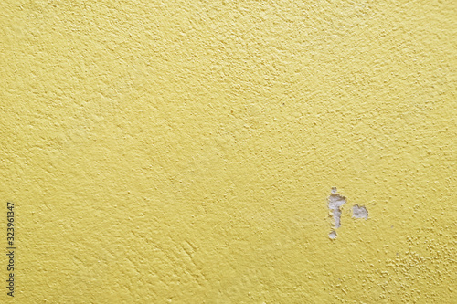 Were cracks warm tone yellow cement wall background clean vintage style and empty space for text,
