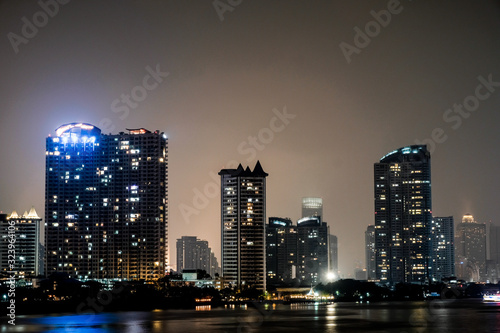 Business architecture, skyscrapers and light trails, Close shot of skyscrapers with lights, Night building.  © suriyapong
