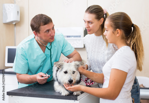 Worried family with dog at veterinarian clinic