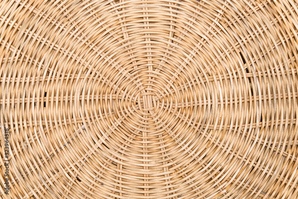 A woven Mat of reeds or straw-yellow in color. The texture of dry cane. Light yellow.