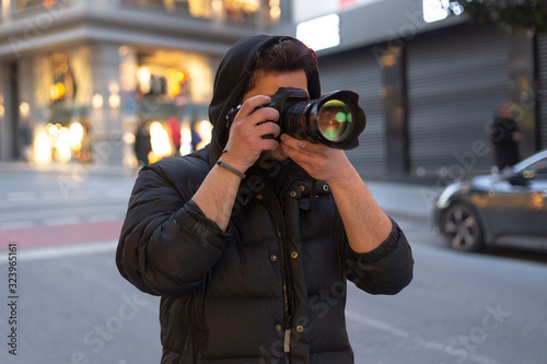 Young photographer taking photos on the streets of the city