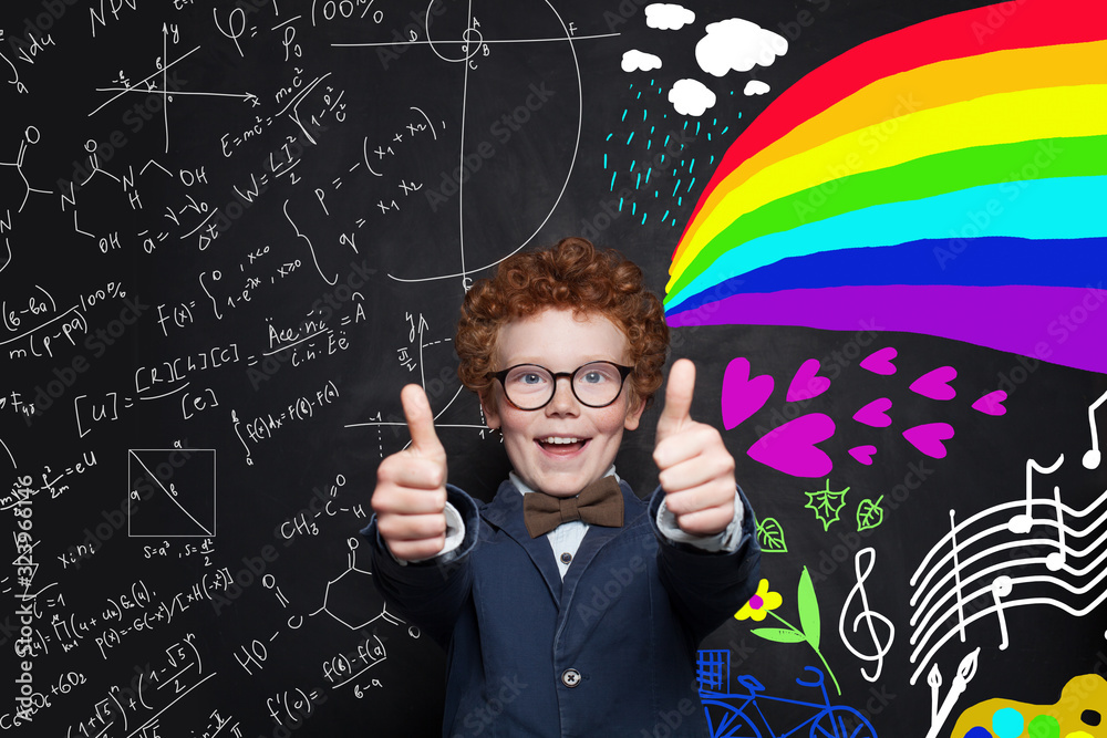 Happy successful child having fun against science formulas and art pattern background Happy successful child having fun against science formulas and art pattern background