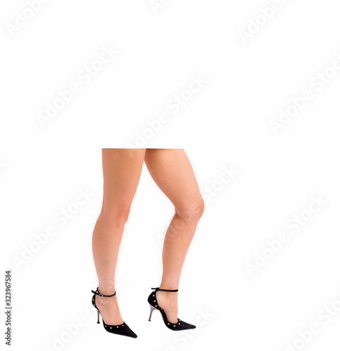 Beautiful female legs in high-heeled shoes. Legs of a young girl on a white background.