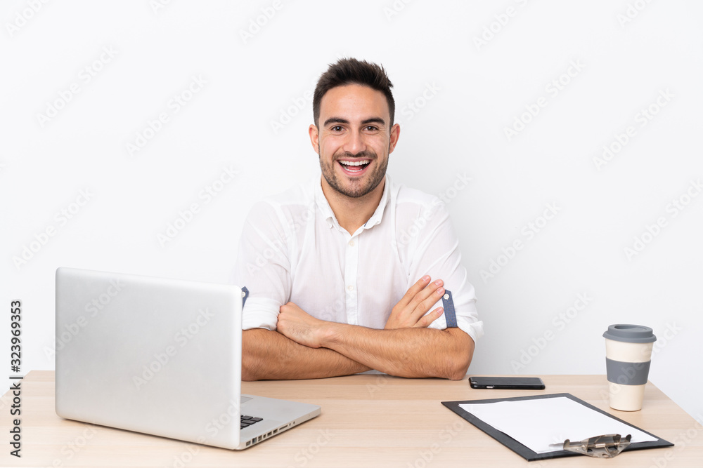 Young business man with a mobile phone in a workplace with surprise facial expression Young business man with a mobile phone in a workplace with surprise facial expression