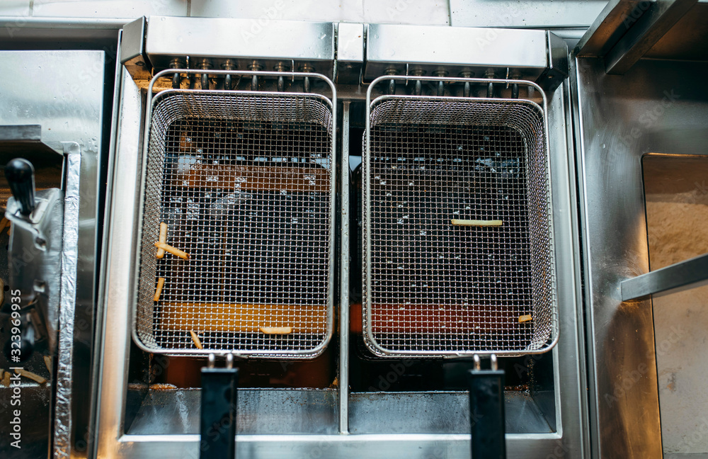 Frying with old oil in kitchen of restoraunt