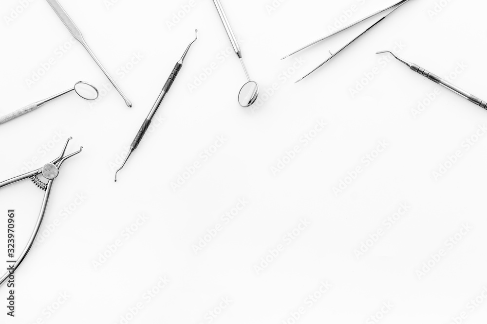 Stomatological tools on dentist's desk on white background top-down frame copy space Stomatological tools on dentist's desk on white background top-down frame copy space