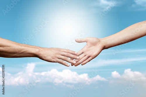 Hands of man and woman reaching to each other © BillionPhotos.com