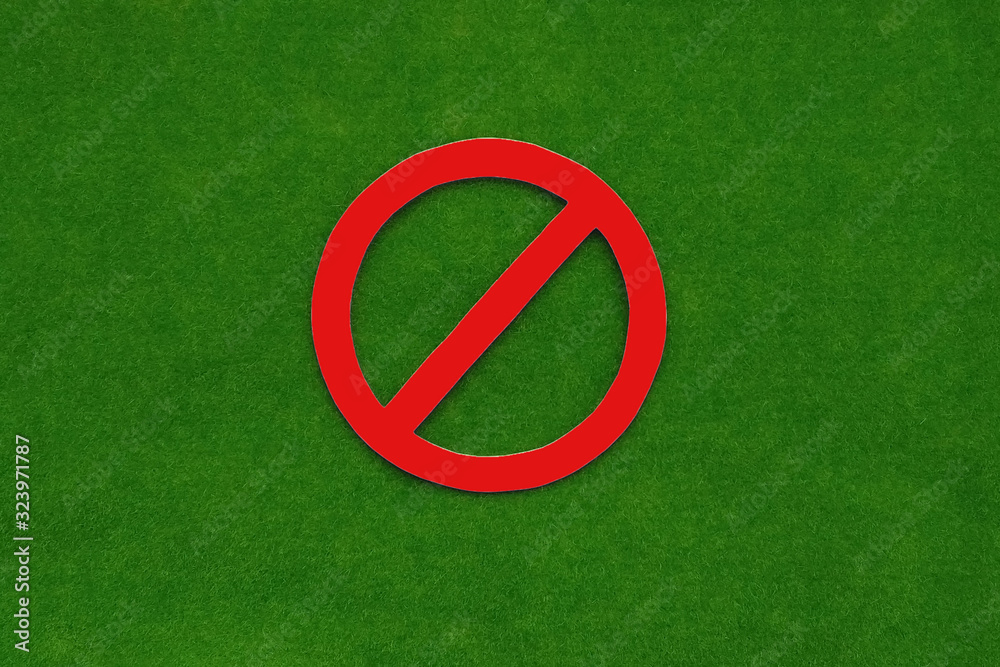 Forbidding sign on a green background. Not allowed.