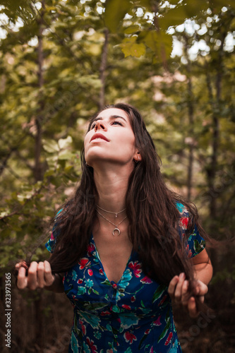 Young smiling woman wearing dress in the forest