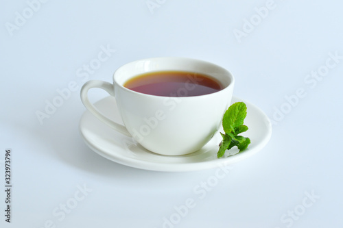 One small cup of tea with mint .