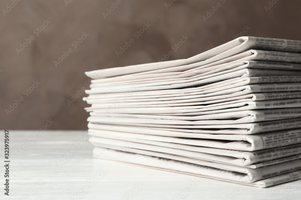 Stack of newspapers on white wooden table. Journalist's work Stack of newspapers on white wooden table. Journalist's work