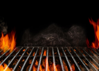 Hot empty portable barbecue BBQ grill with flaming fire and ember charcoal on black background. Waiting for the placement of your food. Close up