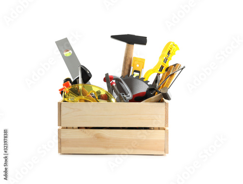 Wooden crate with different carpenter's tools isolated on white © New Africa