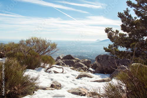 landscape with snow, rocks and trees in top of the mountain with beautiful sky photo