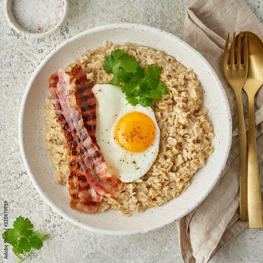 Obraz na plátně Oatmeal, fried egg, fried bacon