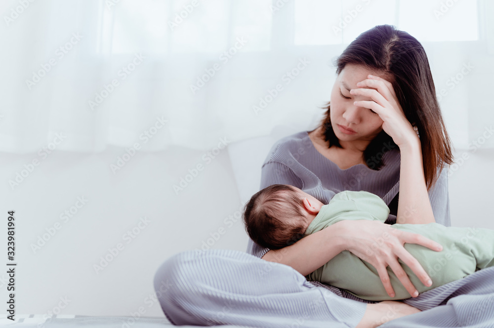 Tired Mother Suffering from experiencing postnatal depression.Health care single mom motherhood stressful.