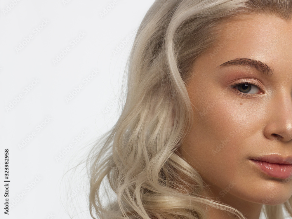 Closeup of half beauty woman with clean skin and natural cosmetics. Beautiful extrem eyelash and full lips of well-groomed girl demonstrate spa procedures, injections in a beauty parlor. Blonde hair Closeup of half beauty woman with clean skin and natural cosmetics. Beautiful extrem eyelash and full lips of well-groomed girl demonstrate spa procedures, injections in a beauty parlor. Blonde hair