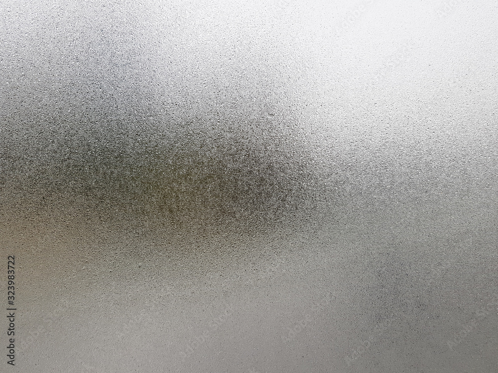 Transparent glass with fog up and water drop on it during winter season.Close up shot of Natural beauty effect. Background and wallpaper concept.