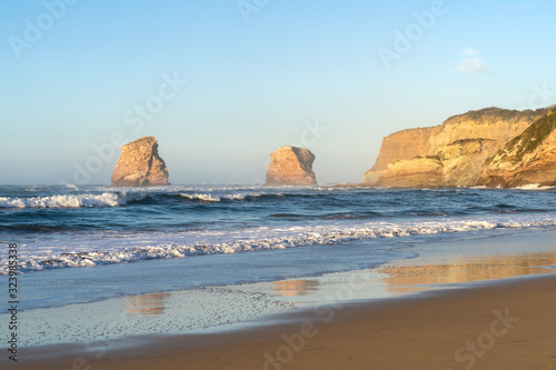 Beach of Hendaye with the two brothers rocks in the background at golden hour. Basque Country of France.