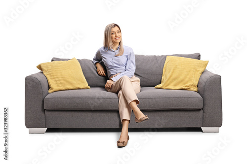 Young woman sitting on a sofa and smiling © Ljupco Smokovski