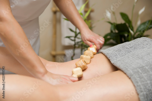 Maderotherapy anti-cellulite massage with wooden roller massager photo