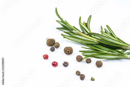 Rosemary and a mixture of multi-colored allspice isolated on a white background.