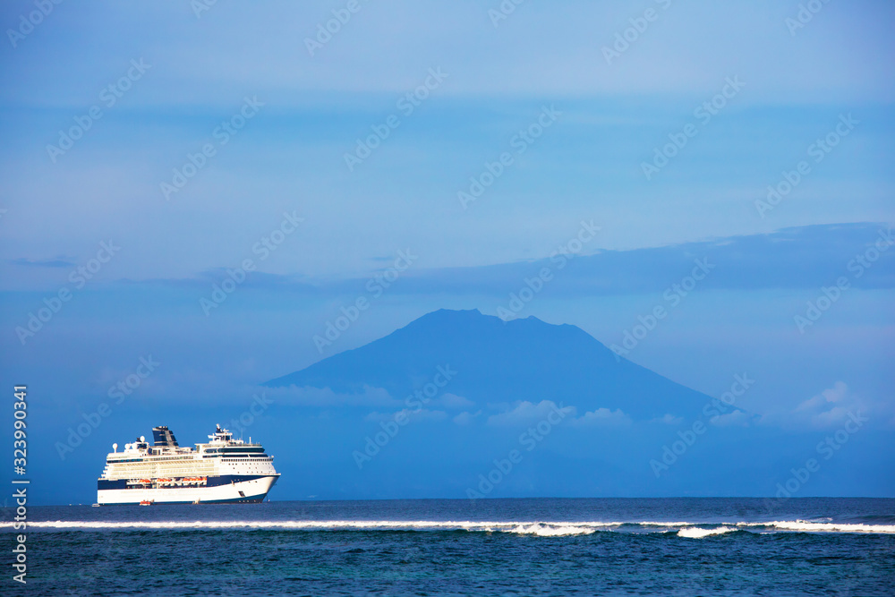 beautiful beach with ocean view, cruise ship and volcano island Bali, Indonesia