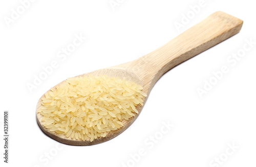 Parboiled rice pile in wooden spoon isolated on white background