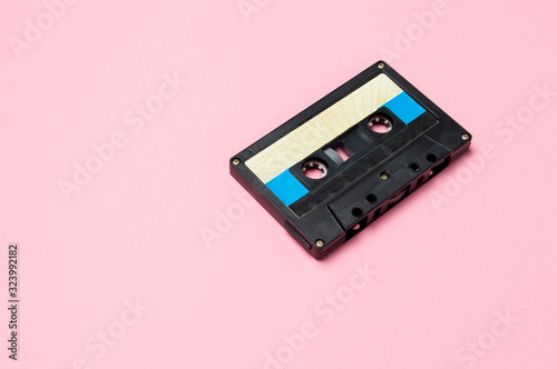 Retro audio cassette tapes on colorful background. Vintage music technology concept.