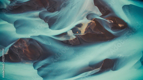 Drone view of blue abstract glacier river in Iceland.