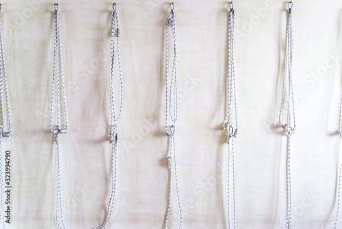Yoga ropes hanging on studio wall. Iyengar yoga props