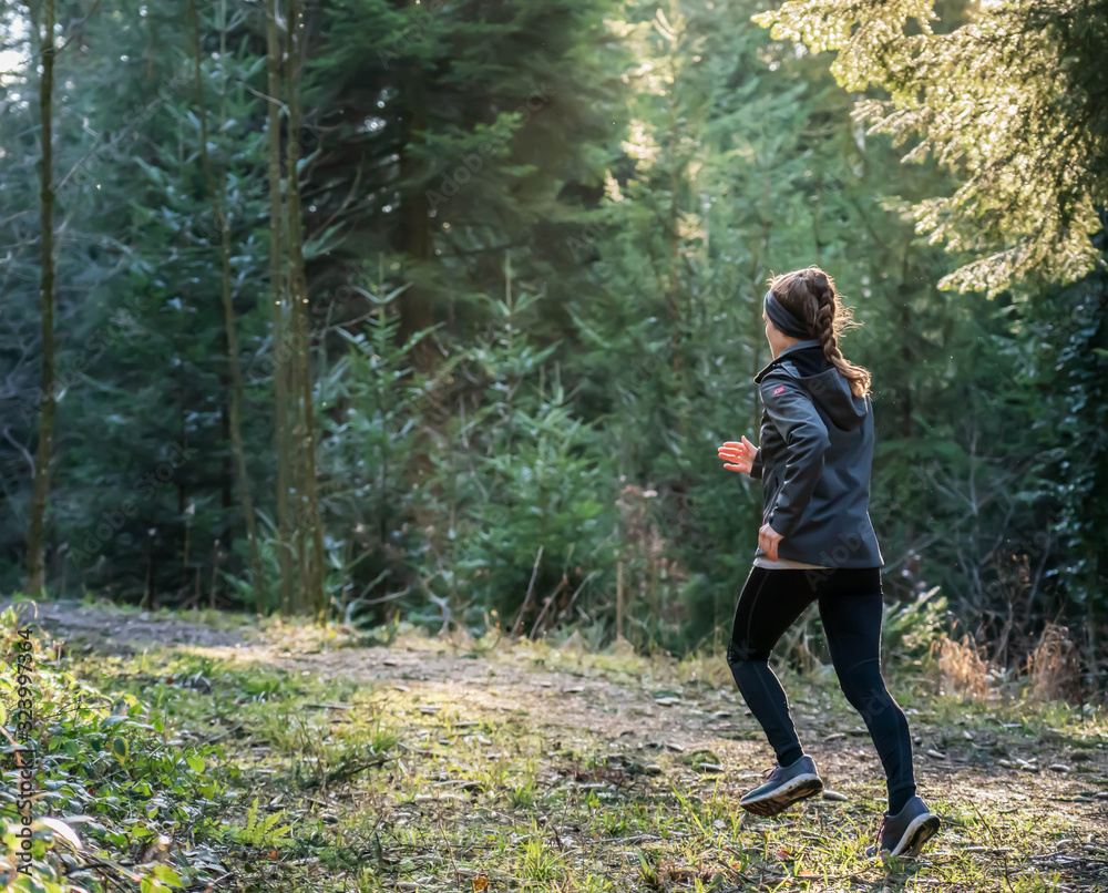 a woman jogging through the woods