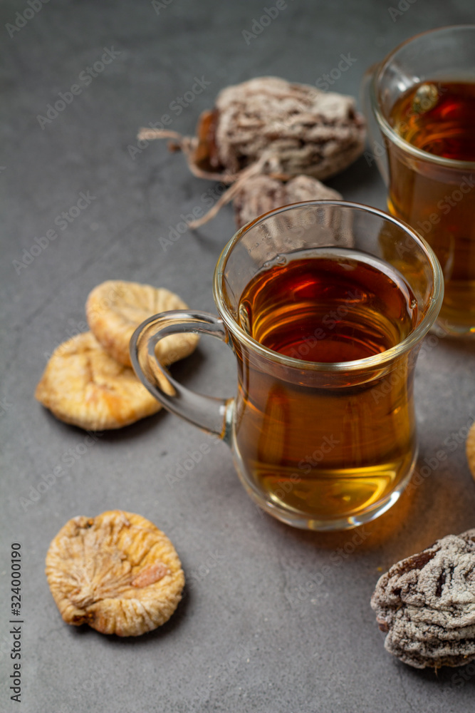 cups of tea and dried fruits from persimmons and figs close-up cups of tea and dried fruits from persimmons and figs close-up