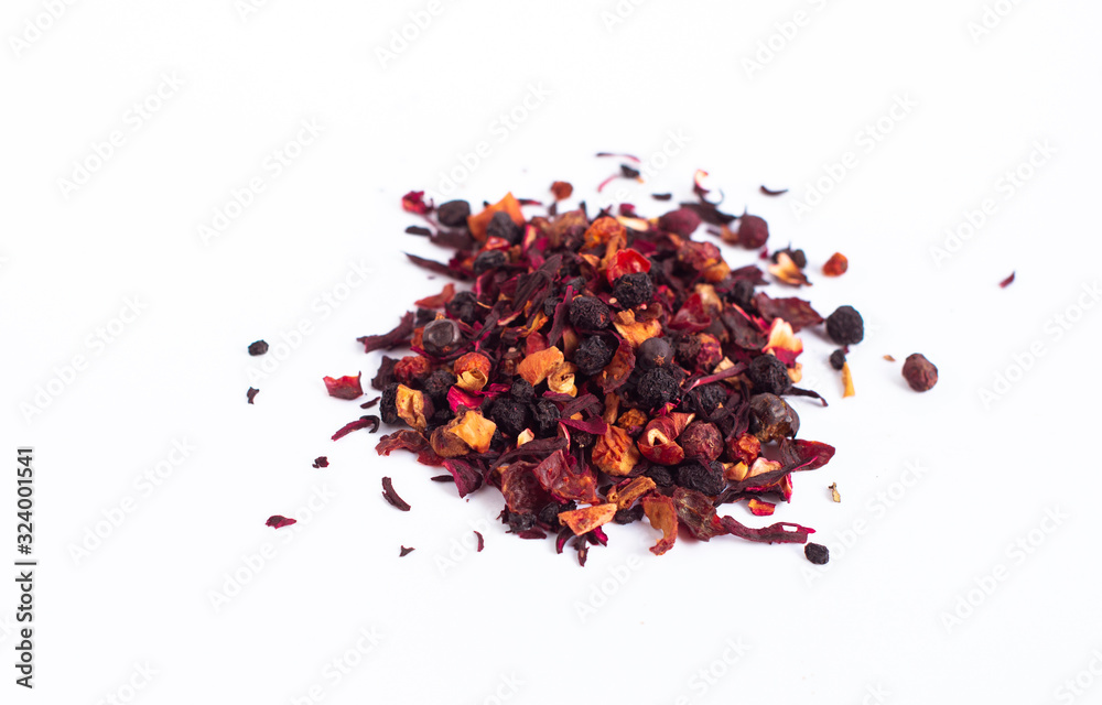  dry tea leaves with petals and fruits on a white background isolated