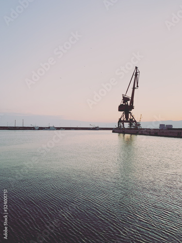 Silhouettes of the cranes in the sea port © Oksana