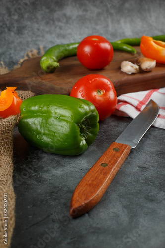 Chilies, tomatoes and a knife.