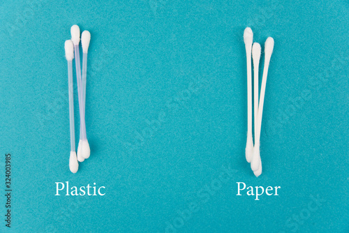 Cotton buds plastic and paper with text on blue background. Concept of Recycling plastic and ecology. Flat lay  top view