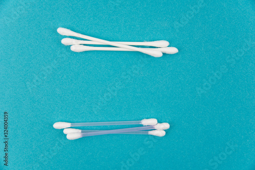 Cotton buds plastic and paper on blue background. Concept of Recycling plastic and ecology. Flat lay, top view