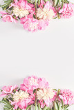 Wedding concept. beautiful frame of pink peony flowers on a white background. top view, flat lay