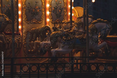 Fényképezés Carousel with horses in amusement park at night