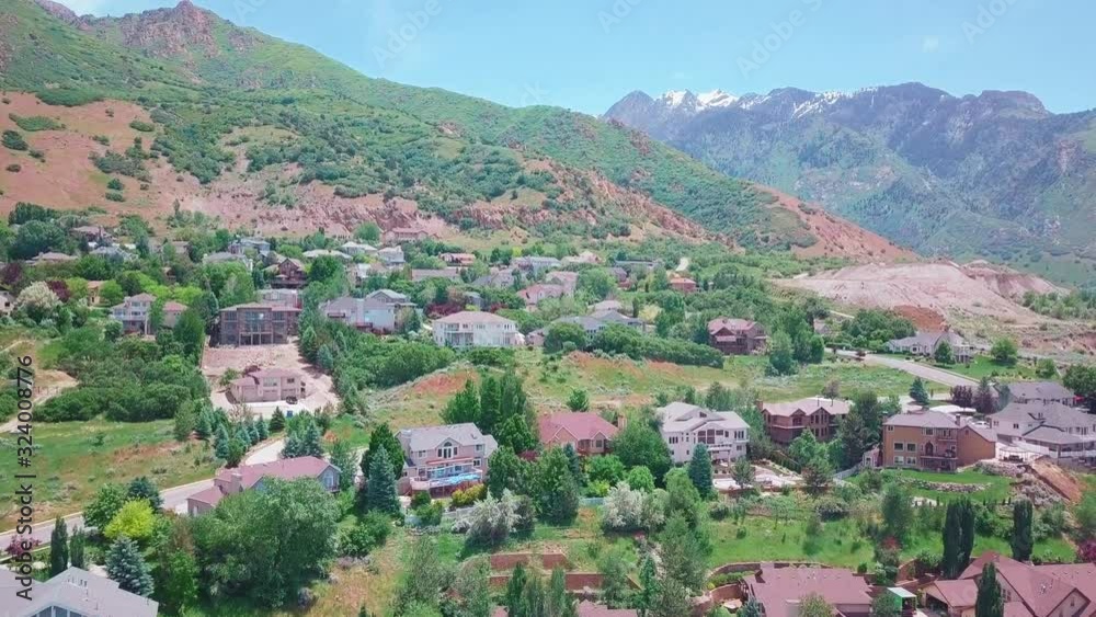 Aerial view. Hilly California Small Village. Forest village behind the yellow flowers. Aerial view. Hilly California Small Village. Forest village behind the yellow flowers.