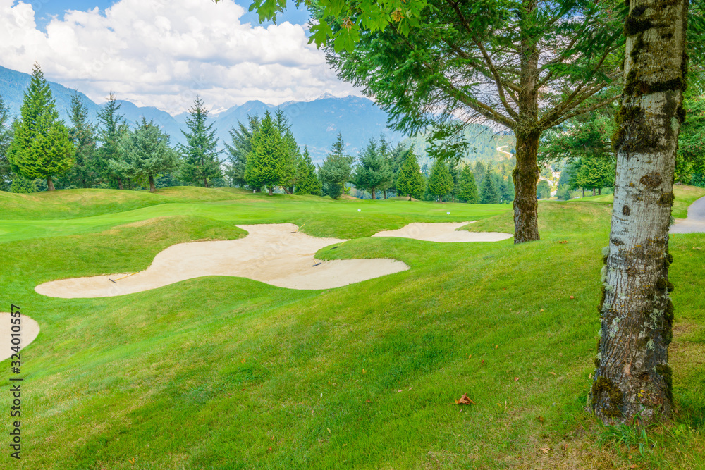 Naklejka premium Golf course with gorgeous green and sand bunker