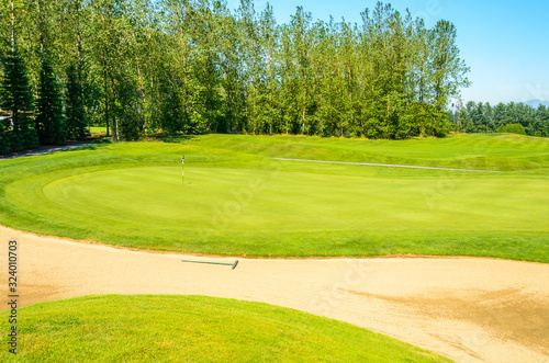 Golf course with gorgeous green and sand bunker © karamysh