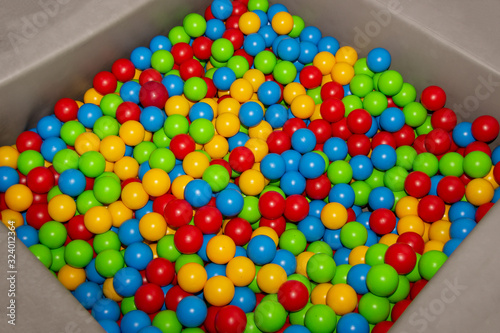 Children's playpen colorful balls. Top down view. photo