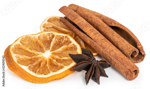 Cinnamon sticks, slices of dried lemon, star anise isolated on white background