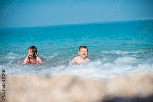 Two kids are playing on the beach