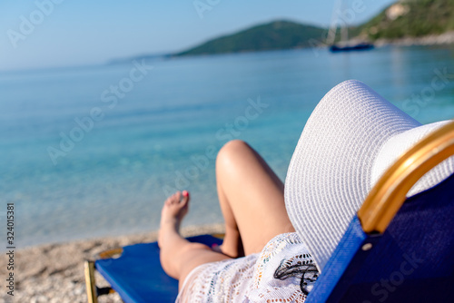 A woman laying and relaxing on the beach
