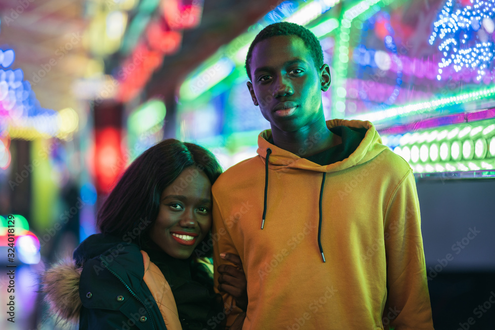 Black couple resting on fairground Black couple resting on fairground